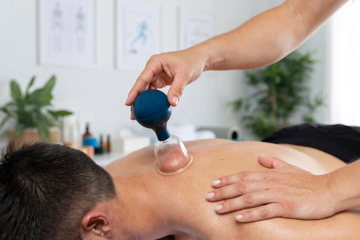 physiotherapist-performing-cupping-session-male-patient_23-2149143822